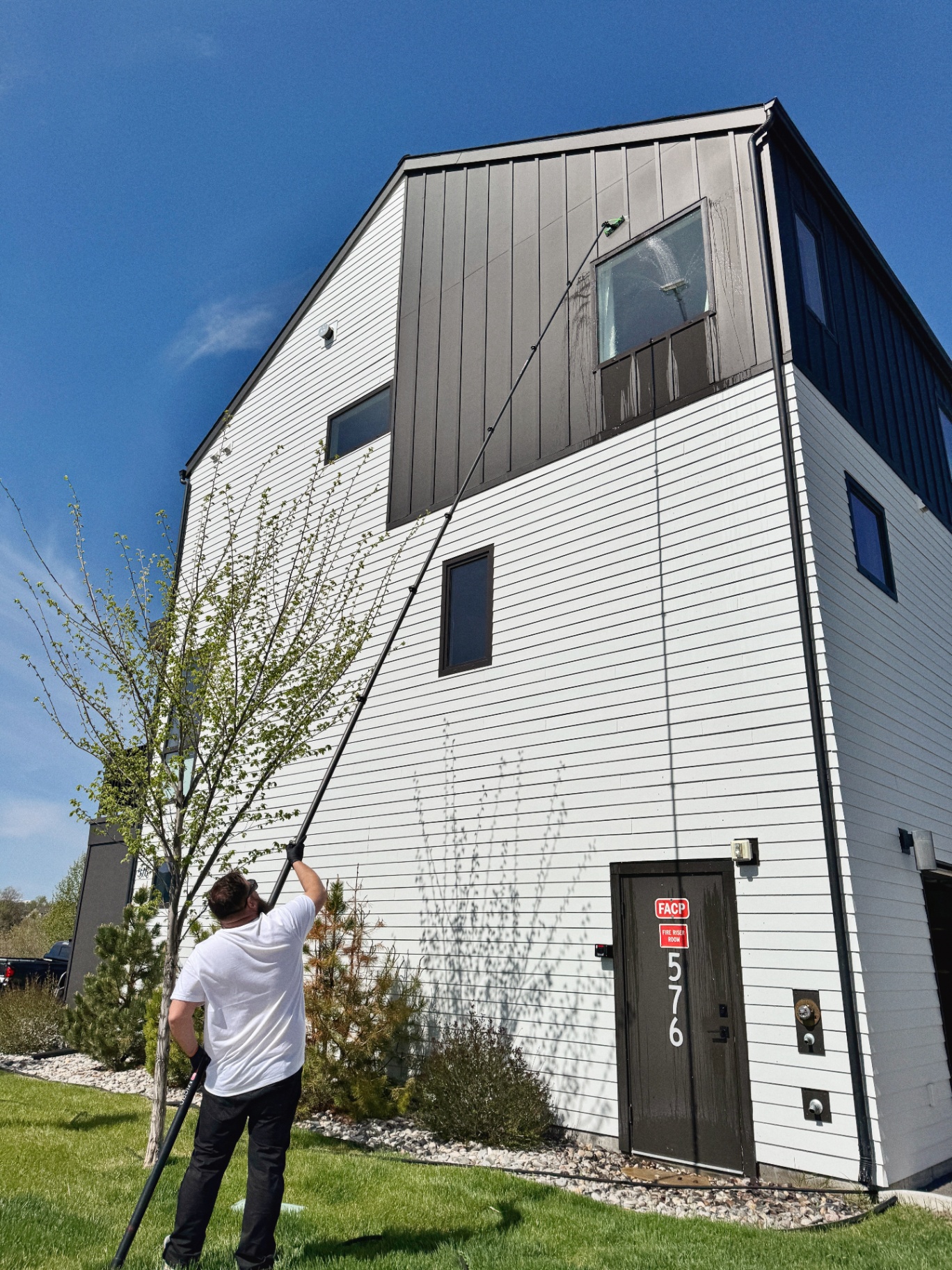 Commercial pole window cleaning on a Doral building